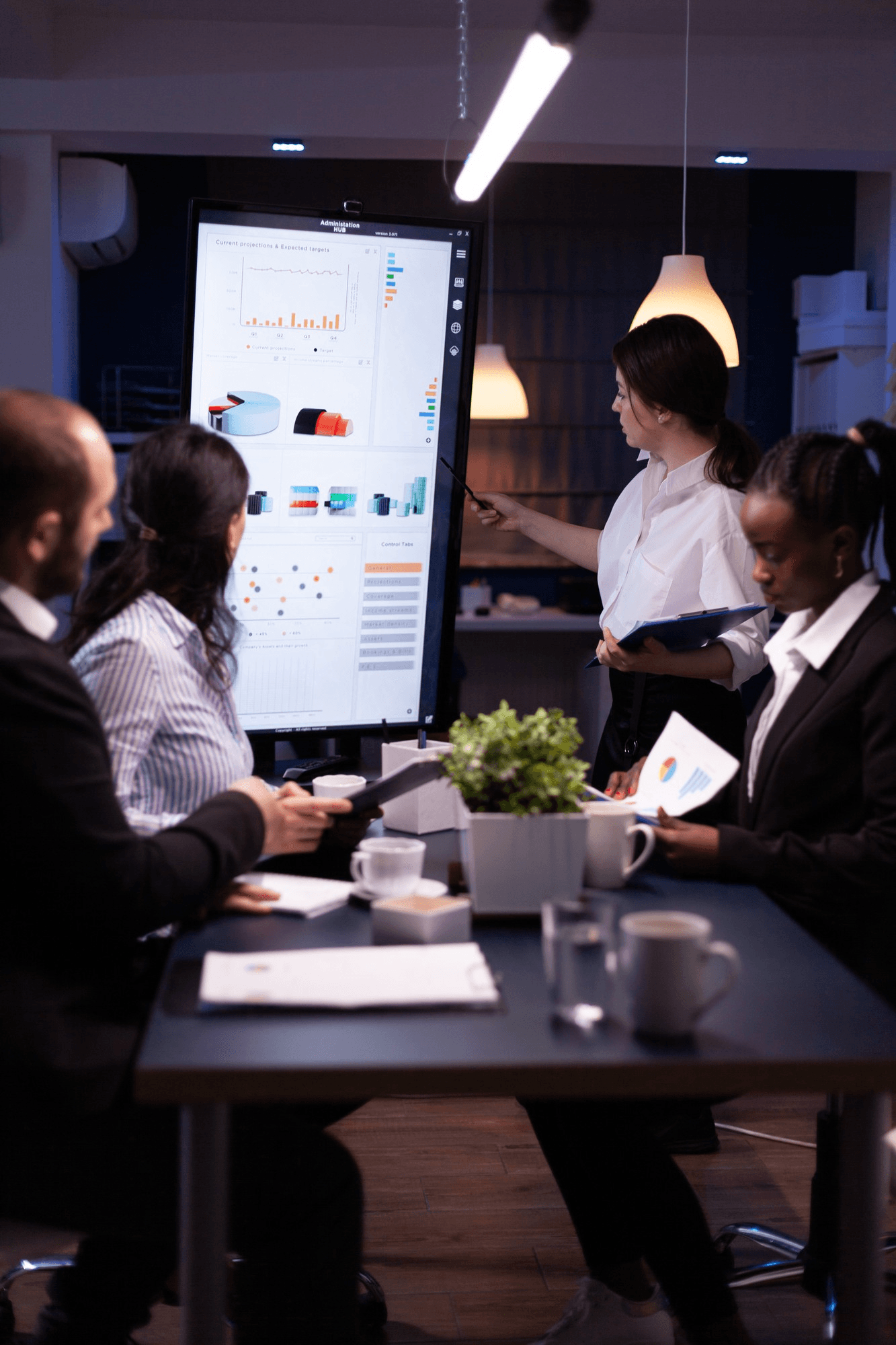 Data analysts collaborating around dashboards during a supply chain disruption